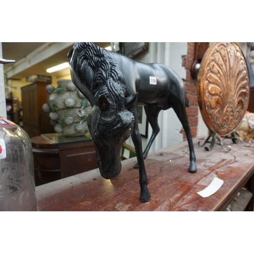 1108 - A black painted metal horse, 69cm long.