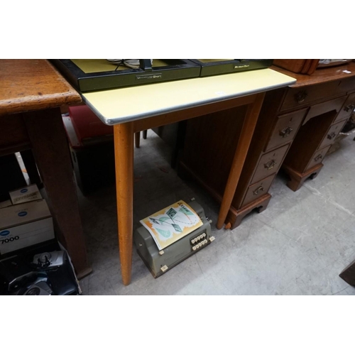 1118 - A mid century oak four drawer chest, 85cm wide; together with a similar formica kitchen table, 90cm ... 