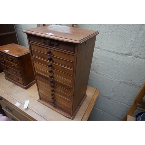 1155 - A miniature mahogany chest of eleven small drawers, 49cm high x 30cm wide x 25cm deep. ... 