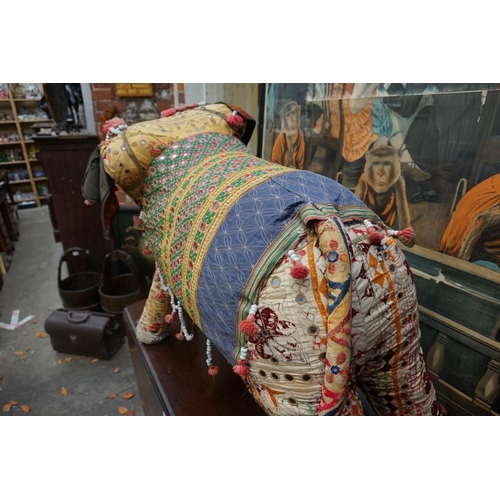 1211 - A large vintage Indian upholstered elephant, applied with small mirrors and with beadwork decoration... 