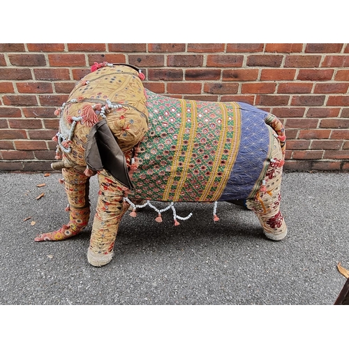 1211 - A large vintage Indian upholstered elephant, applied with small mirrors and with beadwork decoration... 