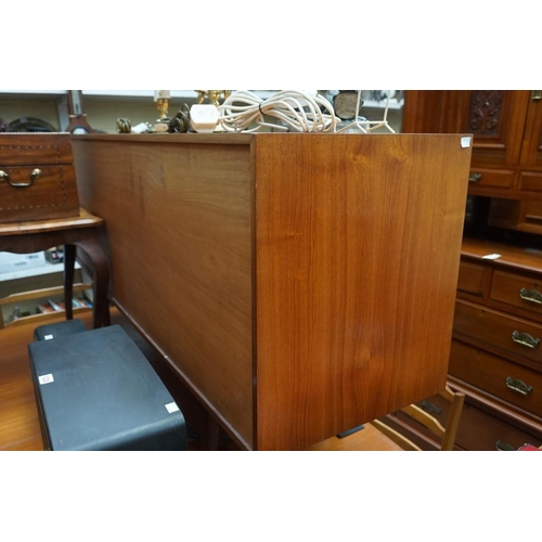 1214 - A vintage Mckintosh teak dining suite, comprising a sideboard, 152cm wide; a drop leaf table, 1... 