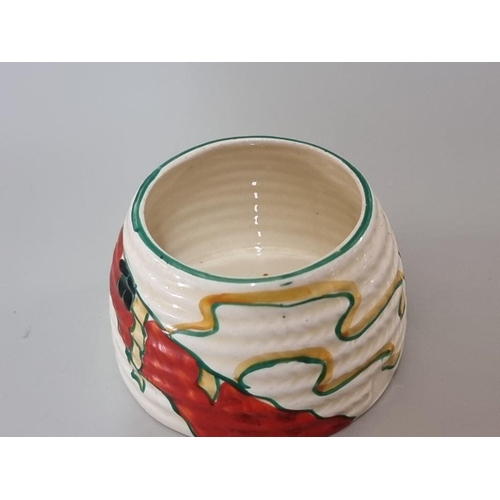 1280 - A Clarice Cliff preserve jar and cover, 7cm high.