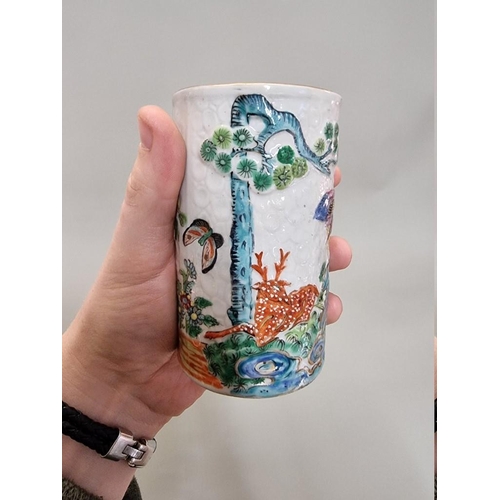 1284 - A Chinese famille rose sleeve vase or brush pot, late 19th century, relief decorated on a textured g... 