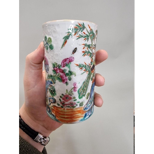 1284 - A Chinese famille rose sleeve vase or brush pot, late 19th century, relief decorated on a textured g... 