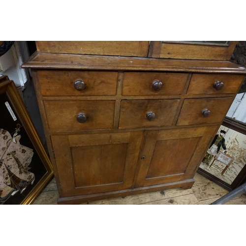 1308 - A late Victorian oak gun cabinet, with glazed doors, 95cm wide.