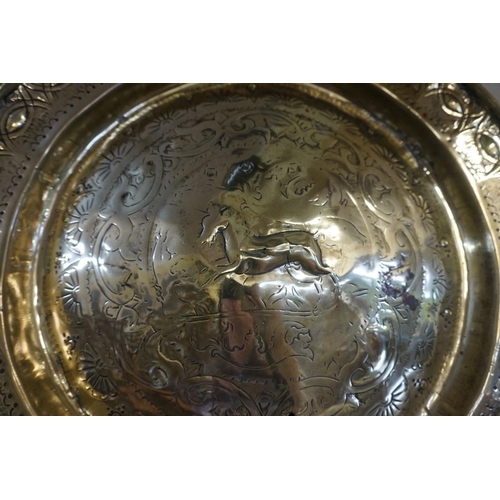 1313 - A brass alms dish, probably 17th/18th century, decorated with a unicorn to the centre, 44.5cm d... 