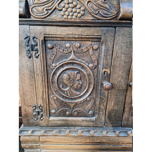 1399 - A 17th century style carved oak court cupboard, attributed to Titchmarsh & Goodwin, 124.5cm wide... 