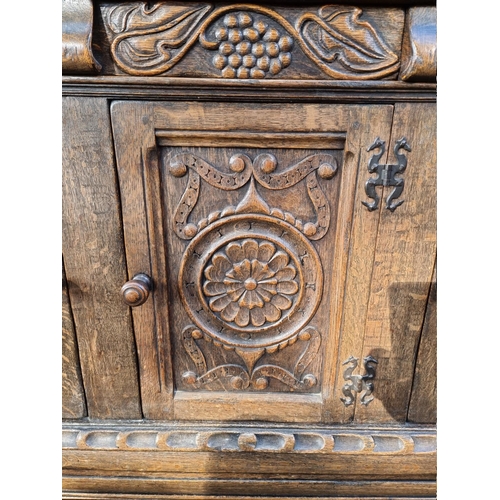 1399 - A 17th century style carved oak court cupboard, attributed to Titchmarsh & Goodwin, 124.5cm wide... 