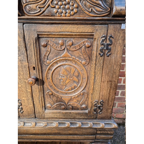 1399 - A 17th century style carved oak court cupboard, attributed to Titchmarsh & Goodwin, 124.5cm wide... 