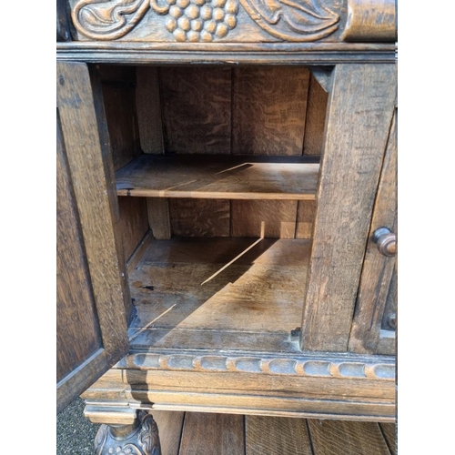 1399 - A 17th century style carved oak court cupboard, attributed to Titchmarsh & Goodwin, 124.5cm wide... 