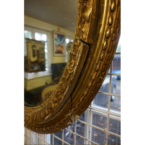 1477 - An 18th century gilt framed oval wall mirror, 95 x 81cm.