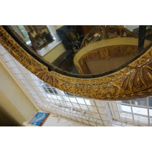 1477 - An 18th century gilt framed oval wall mirror, 95 x 81cm.