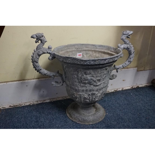 1480 - A pair of lead twin handled urns, probably 17th/18th century, with griffin form handles, 59cm wide.... 