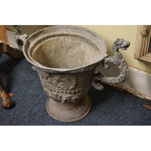 1480 - A pair of lead twin handled urns, probably 17th/18th century, with griffin form handles, 59cm wide.... 