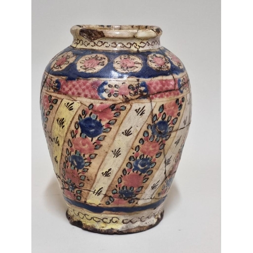 1516 - An early middle eastern glazed pottery vase, 20cm high, (restoration).