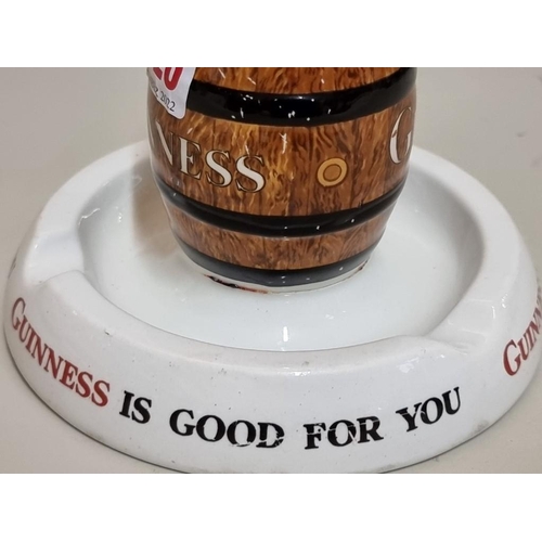 1520 - A Mintons 'Guinness' combined ashtray and matchbox stand, 14cm diameter, (repaired).... 