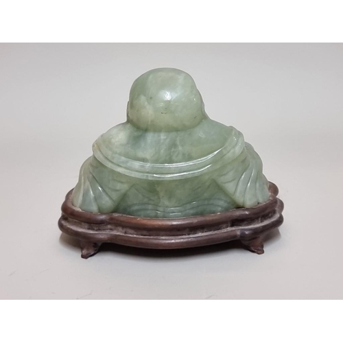 1521 - A Chinese carved green jade Buddha, on fitted wood stand, 11cm high.