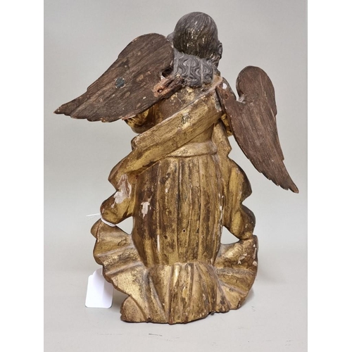 1595 - An antique carved and painted wooden angel, possibly South American, 30cm high.