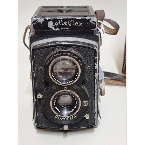 1597 - Cameras: a Rolleiflex, with original leather case. 