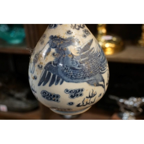 1601 - A Chinese blue and white bottle vase, painted with a phoenix, 23.5cm high; together with four others... 