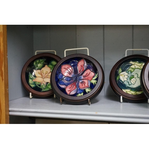 1607 - Seven Moorcroft pin dishes; to include an Anemone Blue pattern 780/4 example, 11.5cm diameter, four ... 