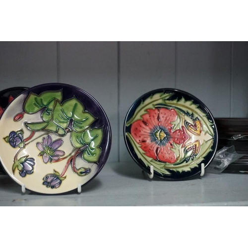 1607 - Seven Moorcroft pin dishes; to include an Anemone Blue pattern 780/4 example, 11.5cm diameter, four ... 