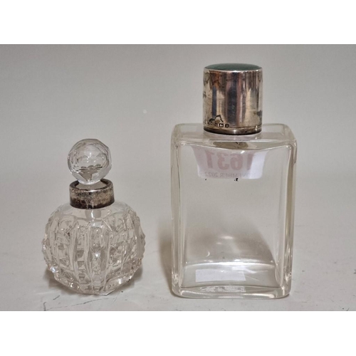 1631 - A silver and guilloche enamel lidded clear glass scent bottle, 10.5cm high; and another. ... 