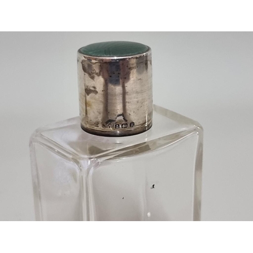 1631 - A silver and guilloche enamel lidded clear glass scent bottle, 10.5cm high; and another. ... 