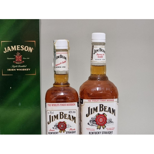 131 - A 1 litre bottle of Jameson Irish whiskey, in oc; together with a 1 litre bottle of Jim Beam bourbon... 