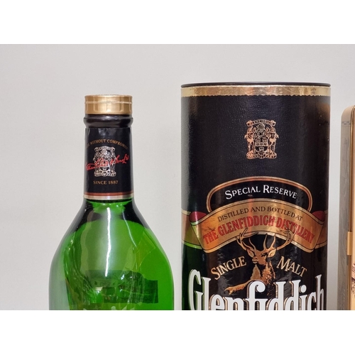 64 - A 1 litre bottle of Glenfiddich whisky, in card tube; together with a 70cl bottle of Glenmorangie 10... 