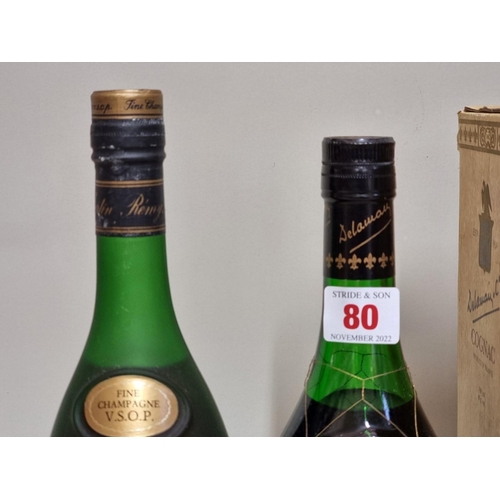 80 - Two old bottles of cognac, comprising: a 24 fl.oz. Remy Martin VSOP; and a Delamain Pale & Dry G... 