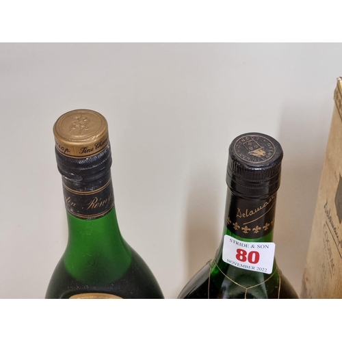 80 - Two old bottles of cognac, comprising: a 24 fl.oz. Remy Martin VSOP; and a Delamain Pale & Dry G... 