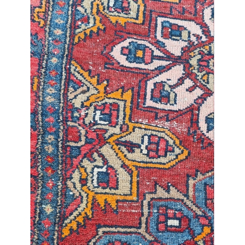 1085 - A Persian rug, having three floral central floral medallions, with geometric borders, 187 x 102.5cm.... 