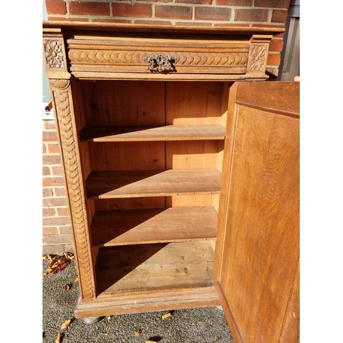 1157 - A Continental carved oak cupboard, 91cm wide. 