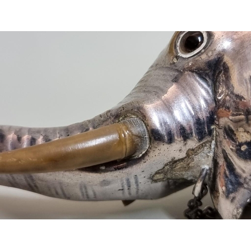 1652 - An electroplated novelty elephant's head funnel or spout, 15.5cm long, (s.d. to one tusk).... 