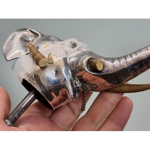 1652 - An electroplated novelty elephant's head funnel or spout, 15.5cm long, (s.d. to one tusk).... 