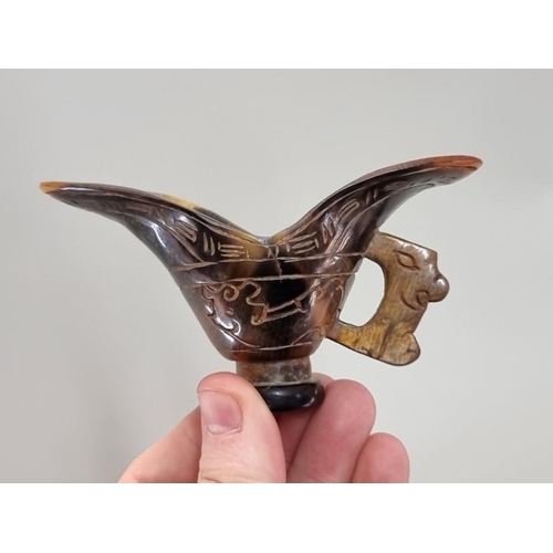 1673 - A Chinese horn libation cup, 10.5cm wide; together with a bone geegaw.