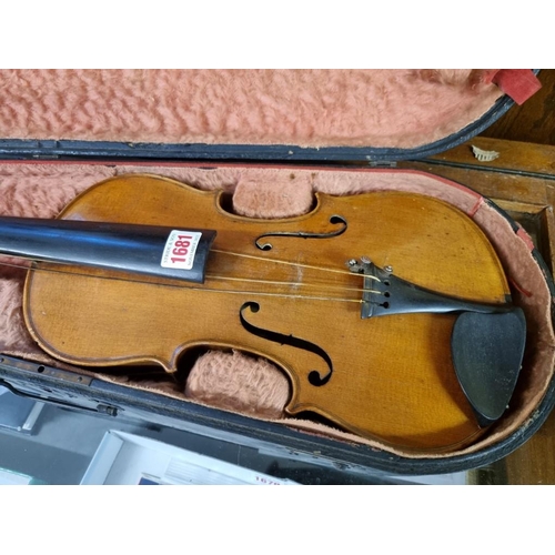 1681 - A Continental violin, with 14in two piece back, with ebonized case. 