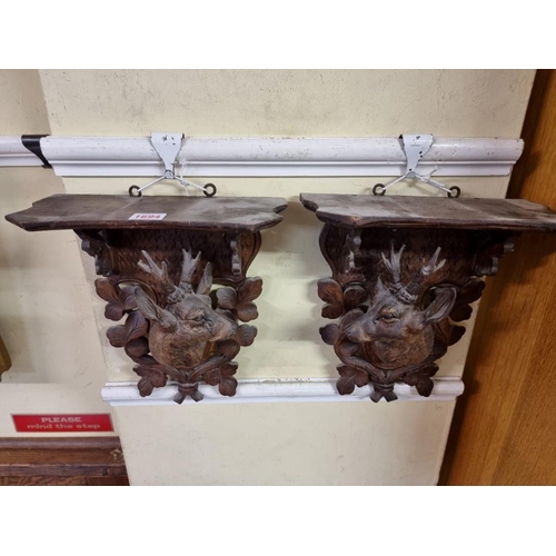 1694 - A pair of Black Forest carved wood stag wall brackets, 31 x 28cm. 