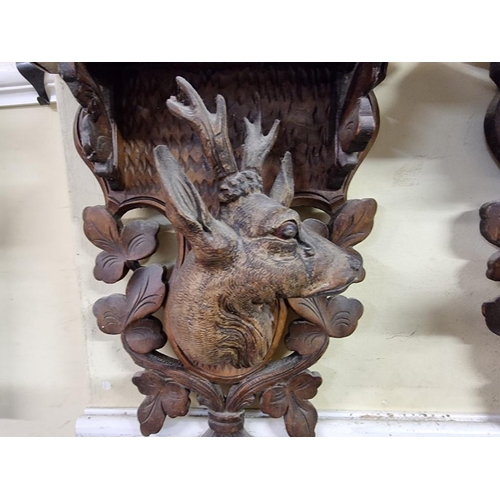 1694 - A pair of Black Forest carved wood stag wall brackets, 31 x 28cm. 