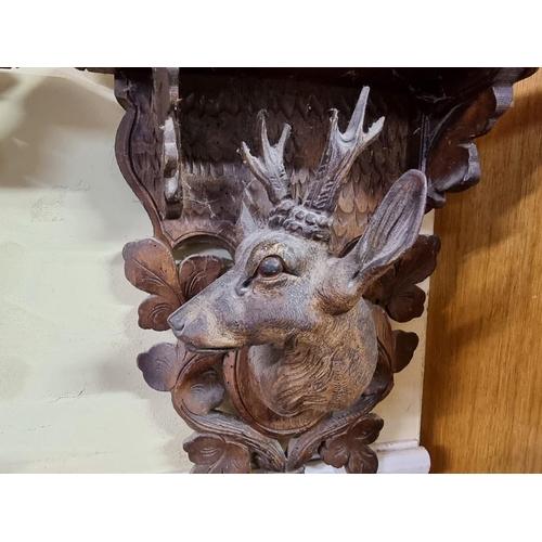 1694 - A pair of Black Forest carved wood stag wall brackets, 31 x 28cm. 