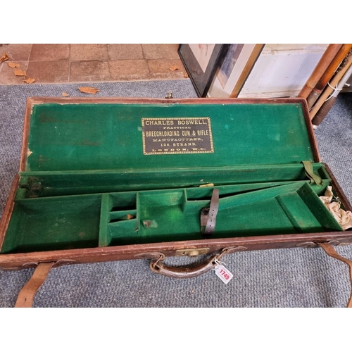 1749 - An old leather and brass bound shotgun case, labelled Charles Boswell. 