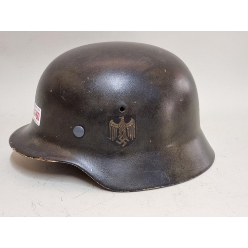 1760 - A German Third Reich M35 pattern steel helmet, bearing two decals, with liner.