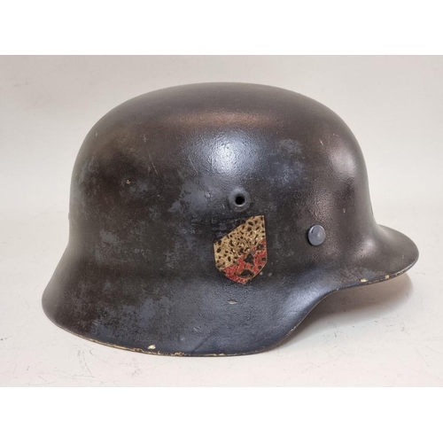 1760 - A German Third Reich M35 pattern steel helmet, bearing two decals, with liner.