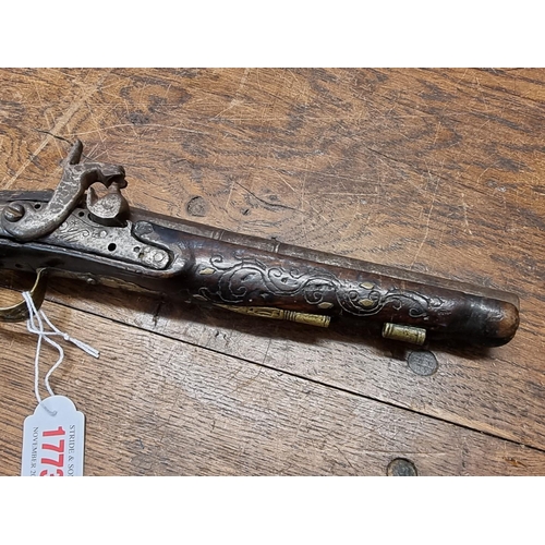 1773 - A 19th century Continental percussion pistol, with brass inlay.