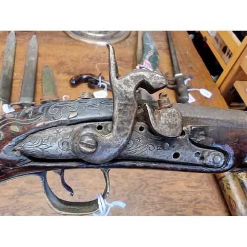 1773 - A 19th century Continental percussion pistol, with brass inlay.