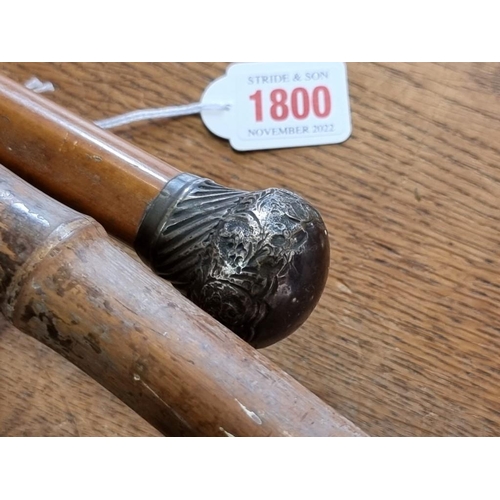 1800 - Two old shooting sticks; a malacca cane; and two others. 