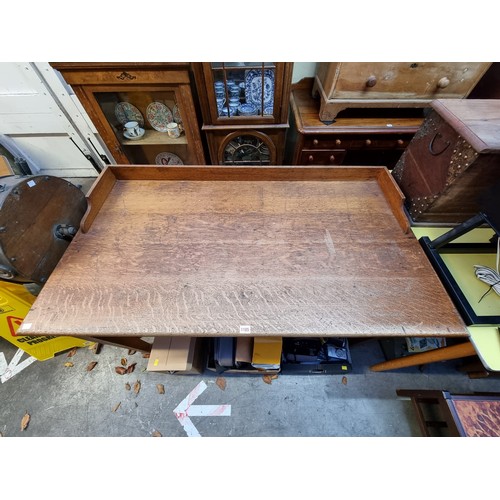 1185 - An early 20th century oak architect's desk, 137cm wide.