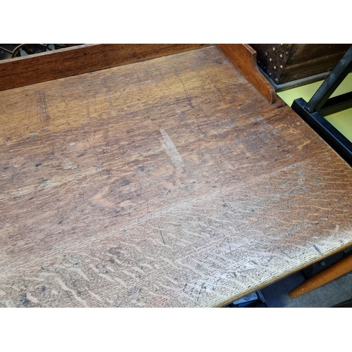 1185 - An early 20th century oak architect's desk, 137cm wide.